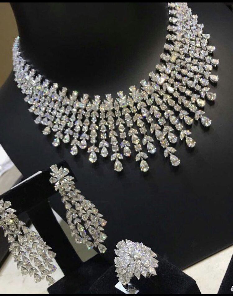 a necklace shown with matching earrings