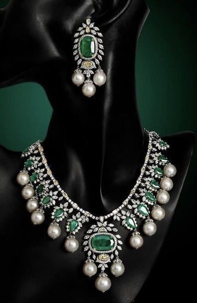 necklace sets with a green-toned center motif shown with matching pieces