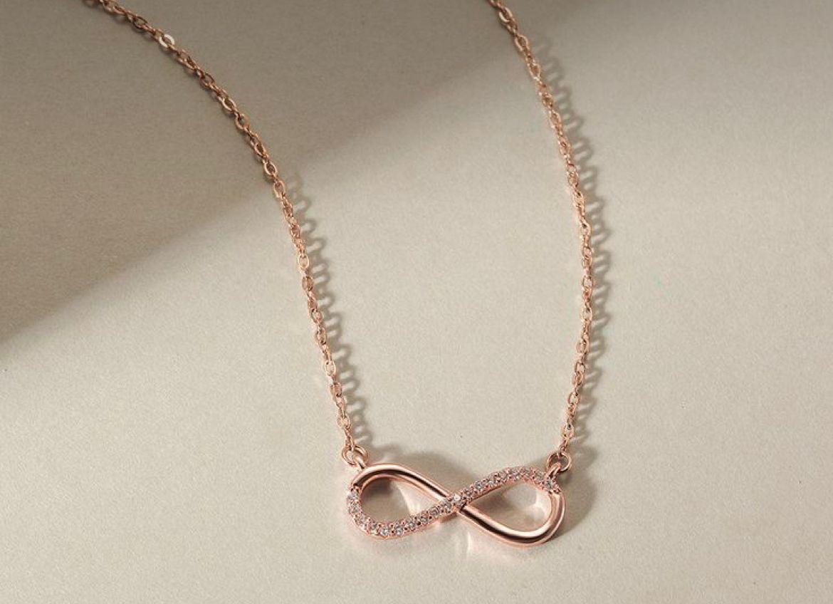 an infinity-shaped pendant on a fine chain