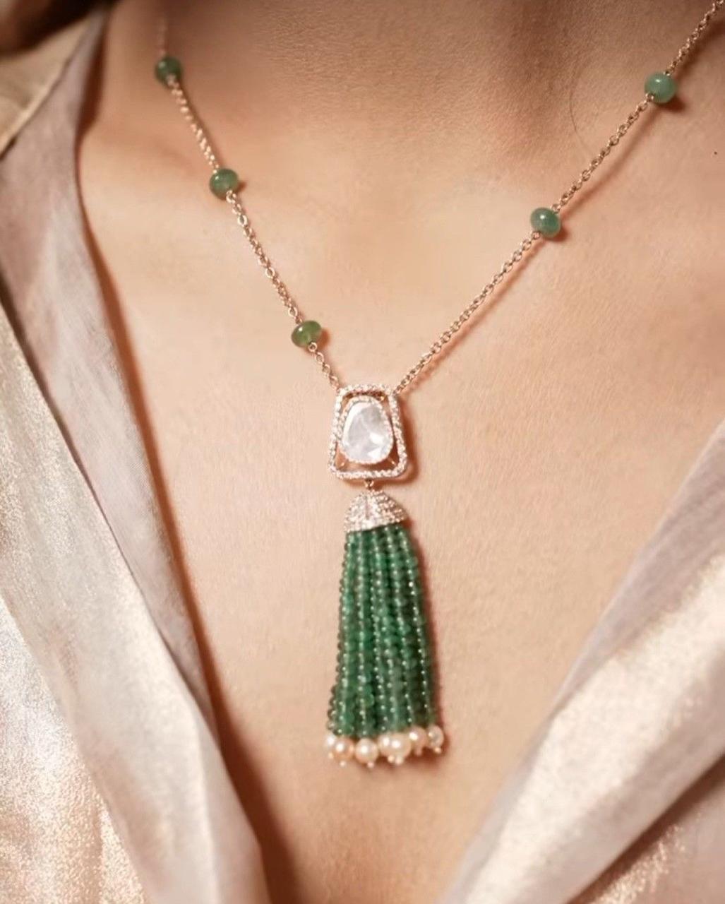 a green-toned center with a long hanging detail