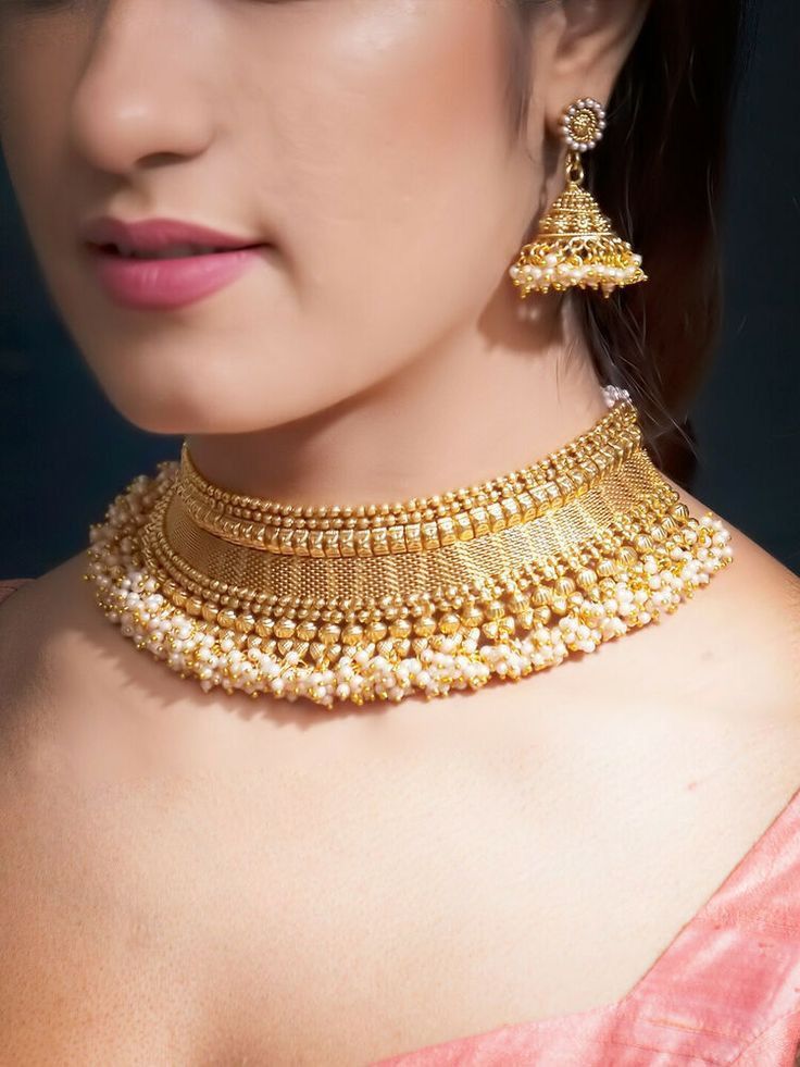 a close-fitting necklace with a central floral detail