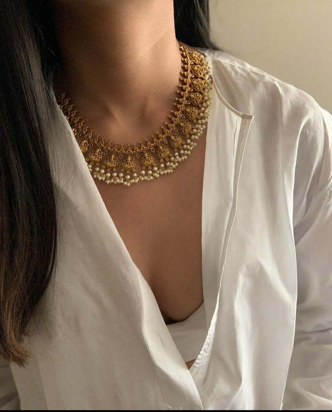 a layered necklace with a centered ornament