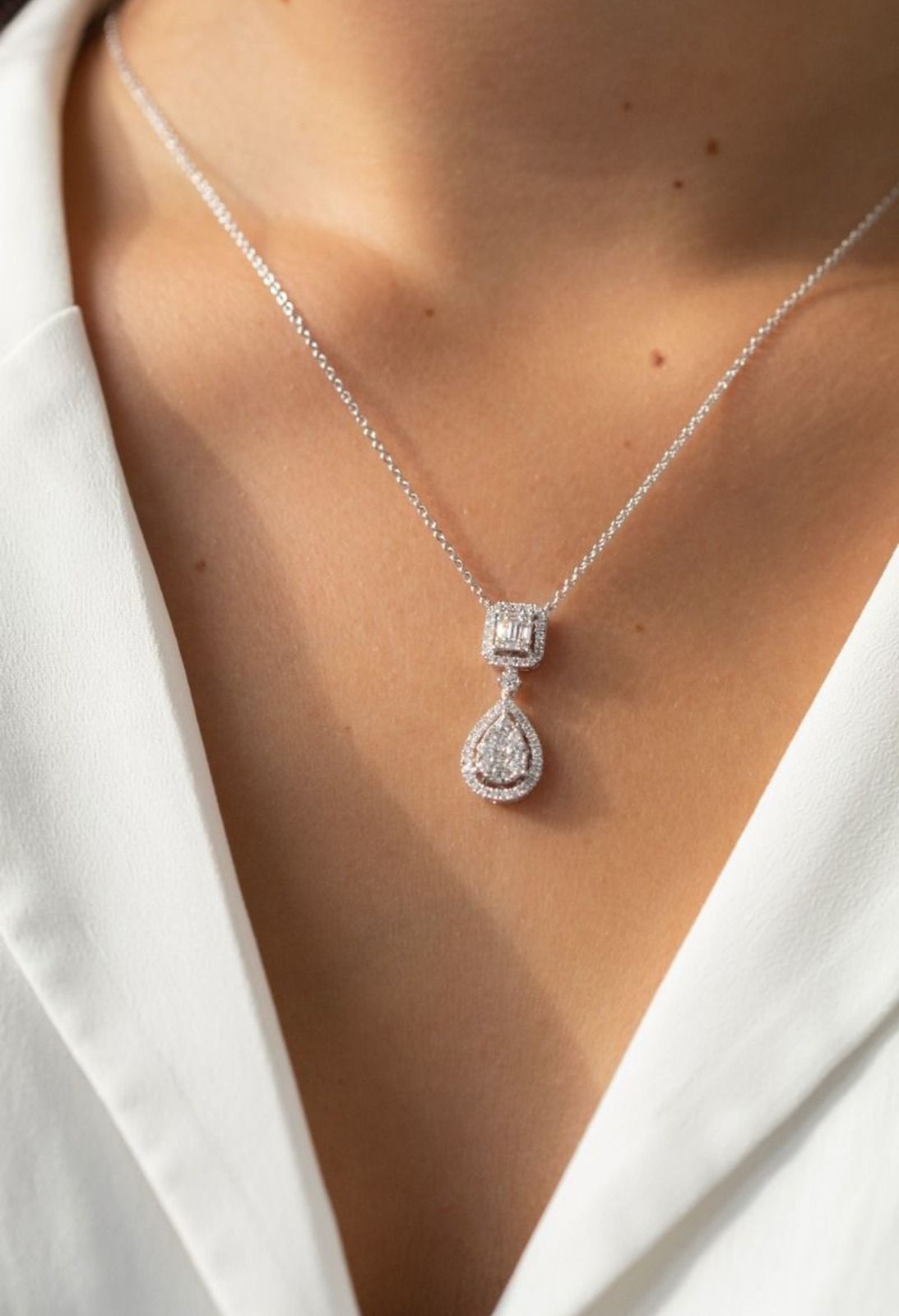 a fine chain with a square frame and hanging center detail