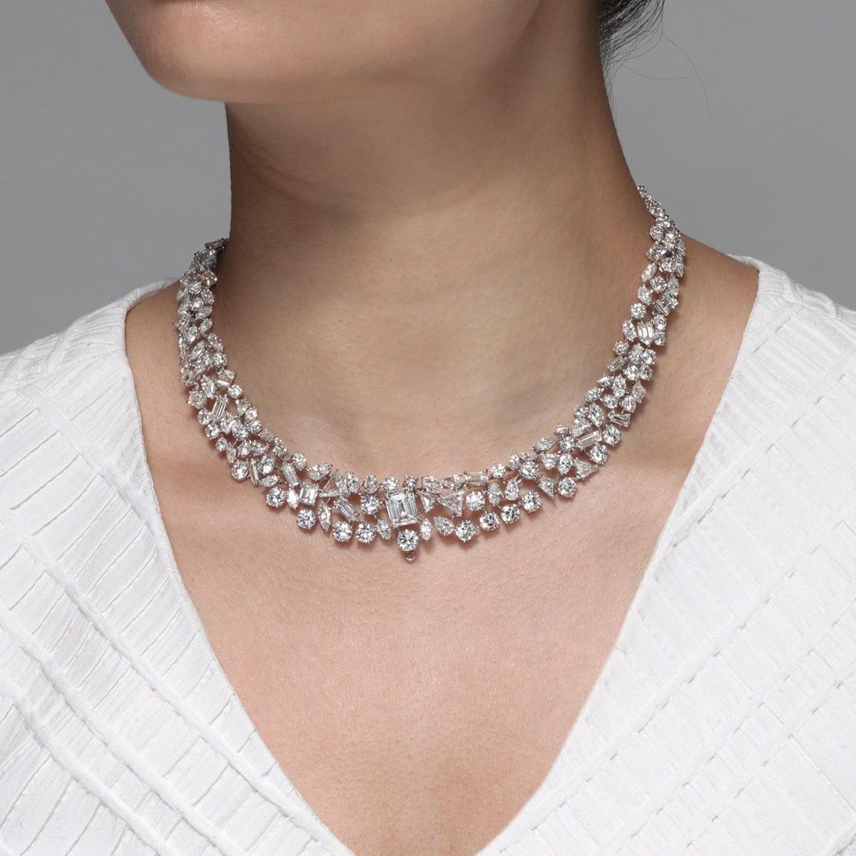a close-fitting necklace with repeated flower-like details