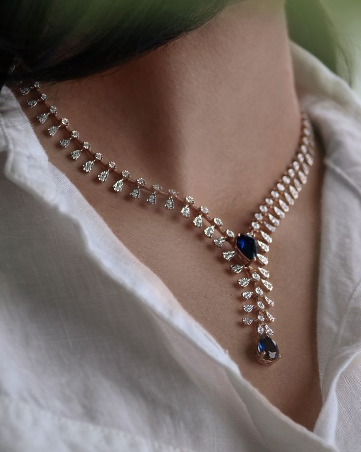 a fine chain with a blue-toned center and hanging details