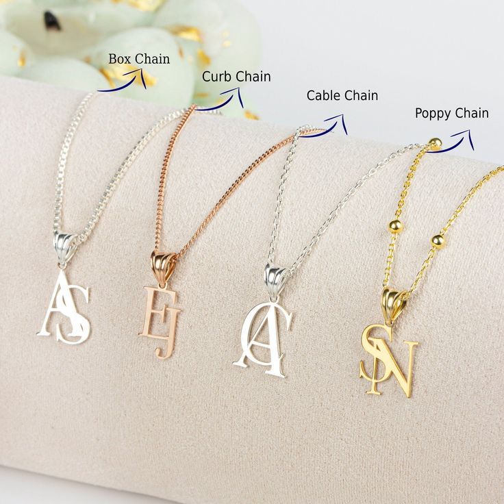 letter-shaped pendants shown on necklace chains
