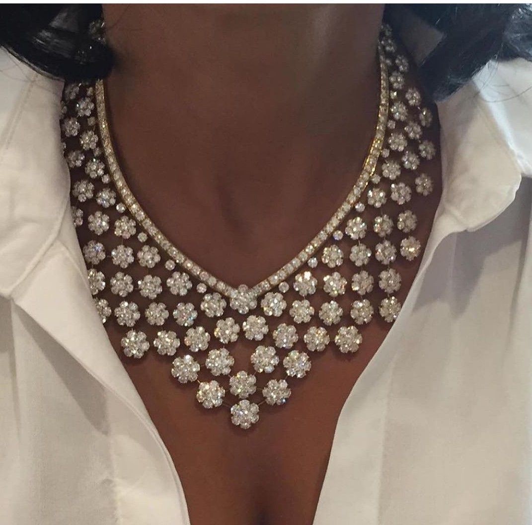 a curved collar with repeated pale hanging accents