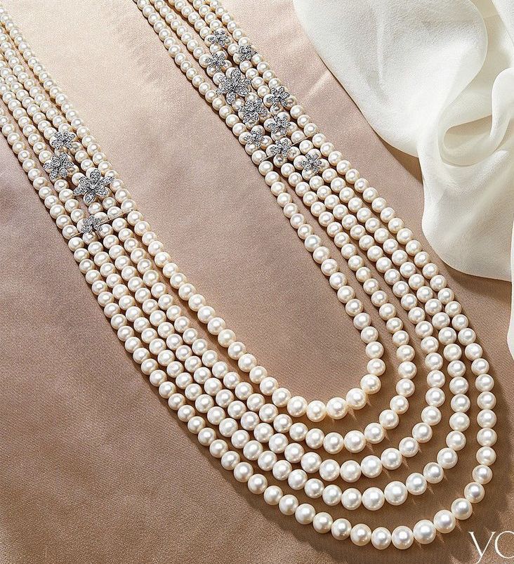 three graduated rows of pale round beads