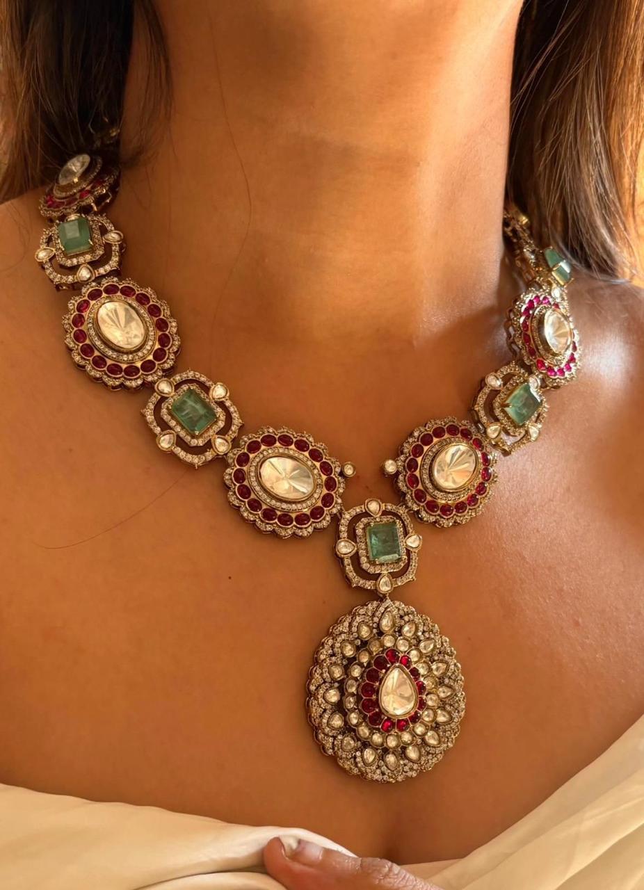 a necklace with a central green-toned hanging detail