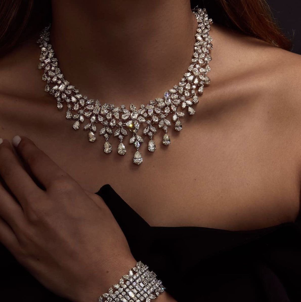 a necklace with repeated leaf-shaped details and hanging accents