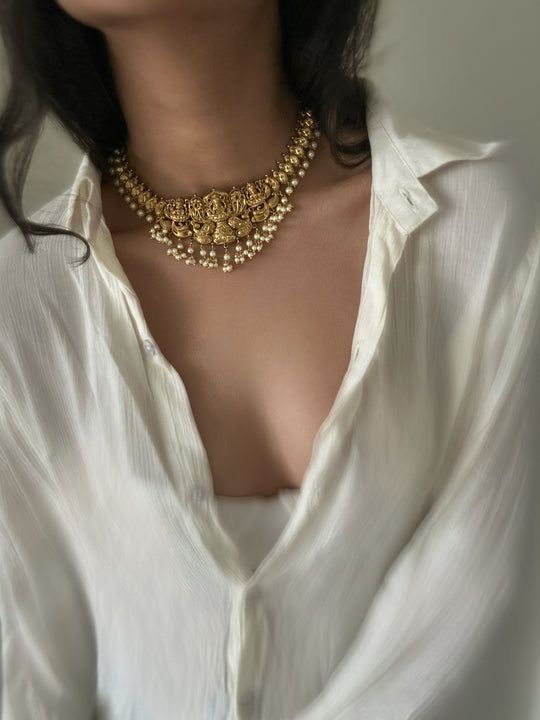 a long necklace with a central hanging detail