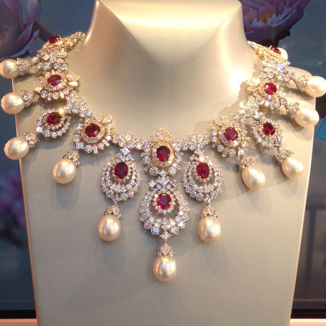 Necklace featuring a vivid red-toned center and a row of hanging accents