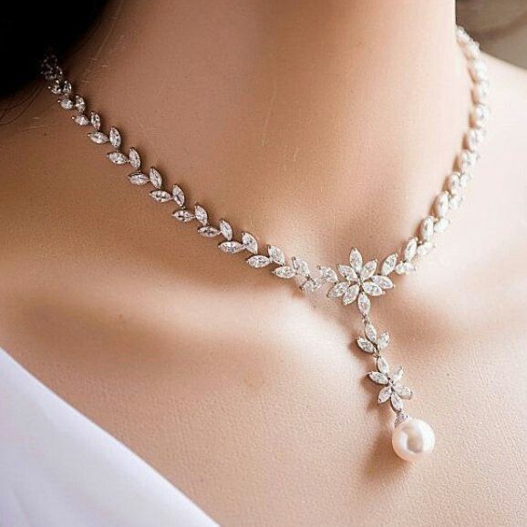 a delicate chain ending in a leaf-like drop and rounded accent