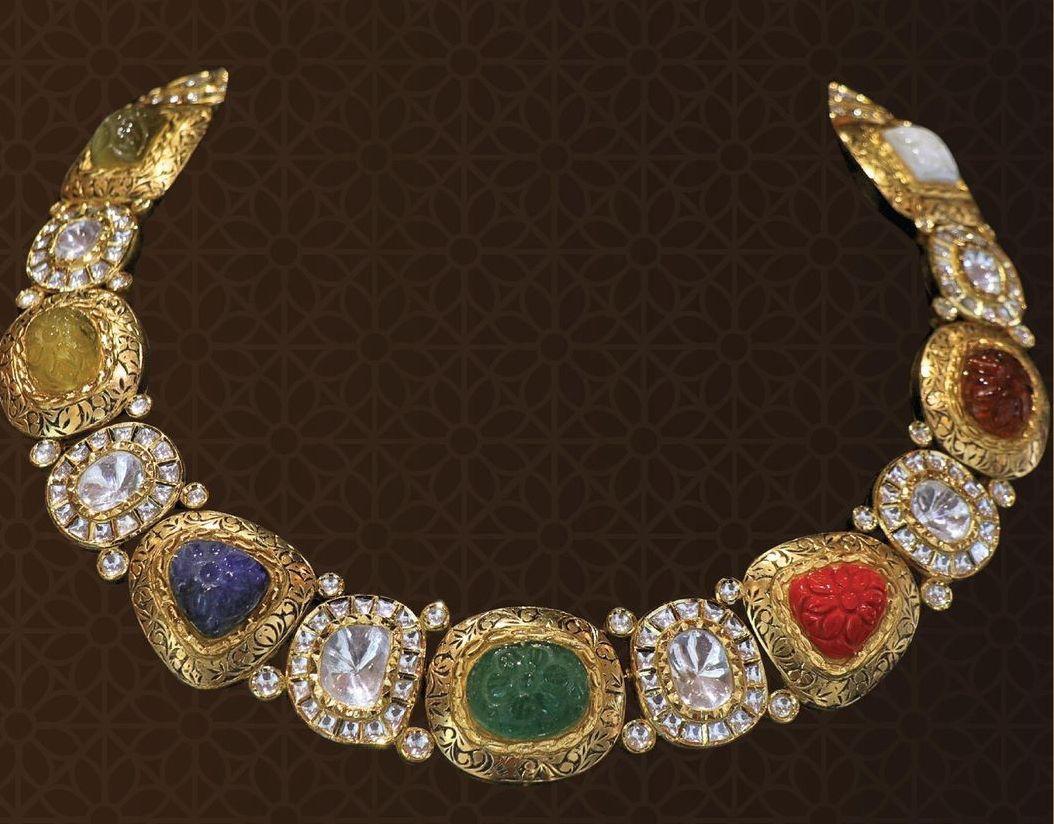 a curved necklace with repeating multicolor framed details