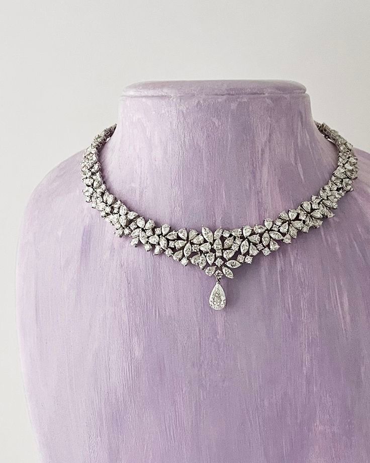 a close necklace with repeated flower-like details