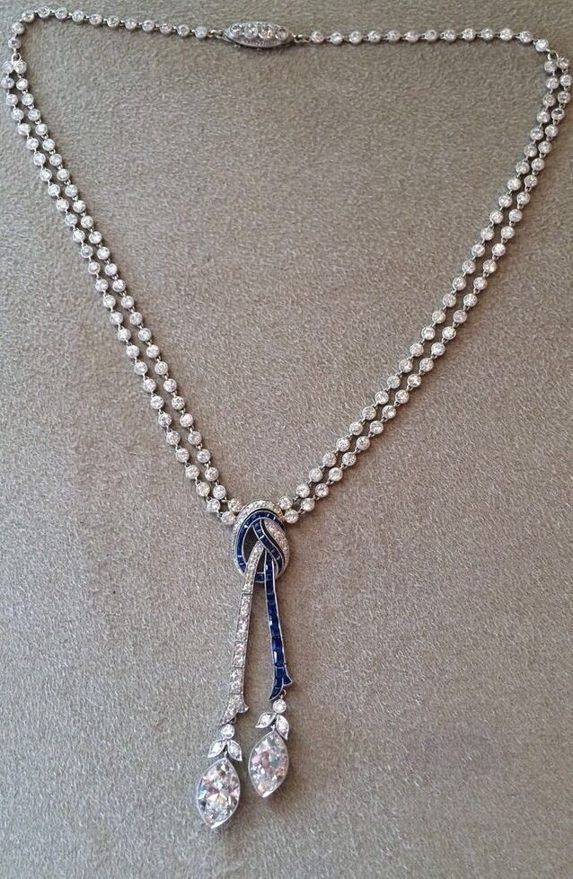 a fine chain with a centered blue-toned pendant