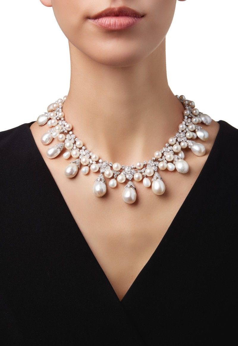 necklaces with a curved row of pale round details with hanging drops
