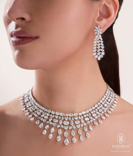 a curved necklace with repeated pale drops