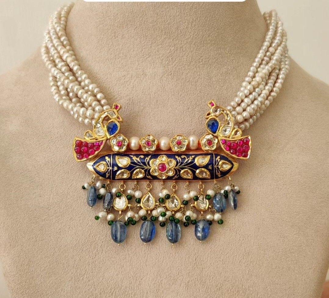a necklace shown with matching earrings