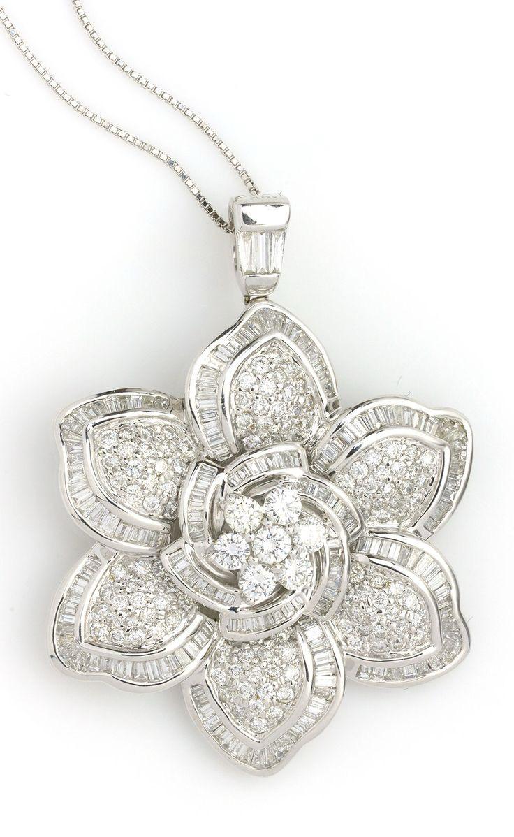 a flower-shaped pendant with a central raised detail