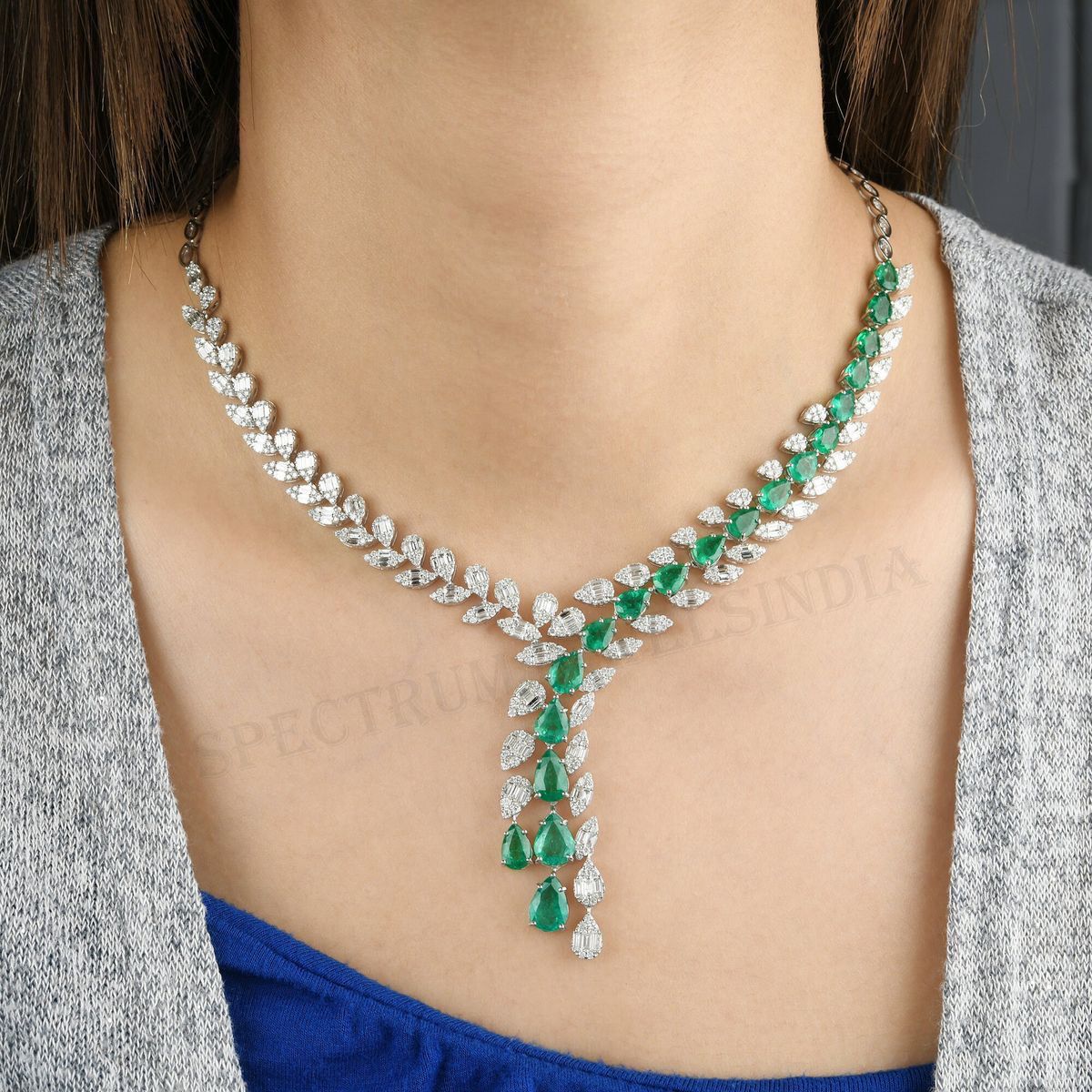 a necklace with green-toned accents spaced along the chain