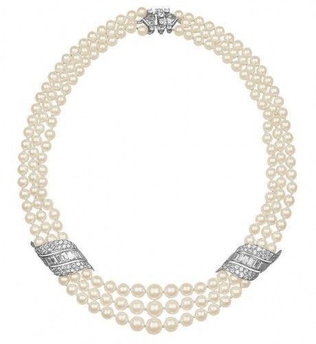 Necklace featuring multiple pale bead strands