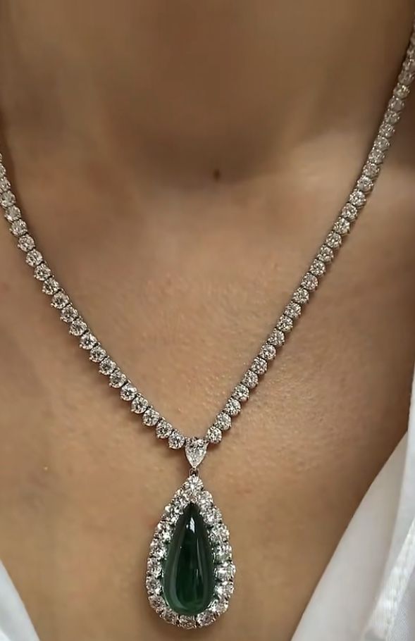 a green-toned hanging detail on a fine chain