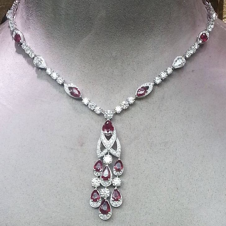a fine necklace with a red-toned center and long hanging details