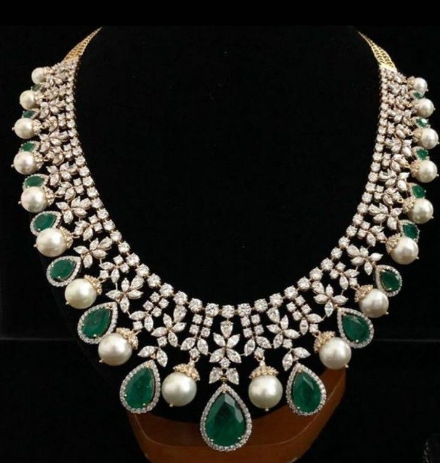 necklaces with green-toned accents arranged around a central drop