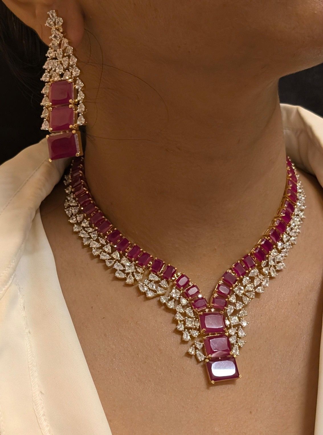 a necklace with red-toned centers and hanging accents