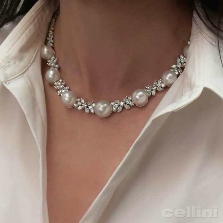 necklaces with small floral details spaced along a fine chain