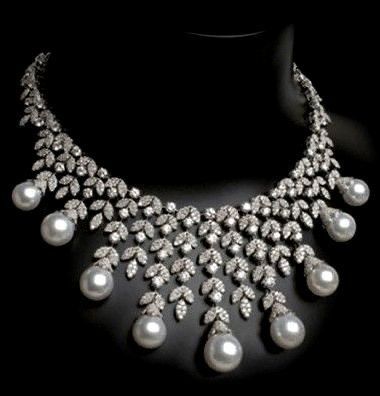 necklaces with a curved arrangement of clustered bright details and drops