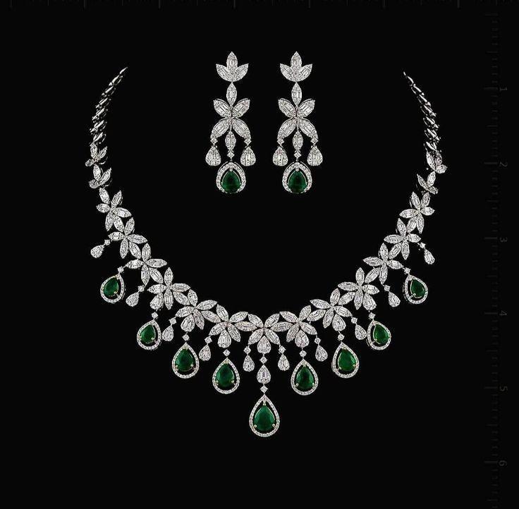 a green-toned pendant with matching earrings shown together