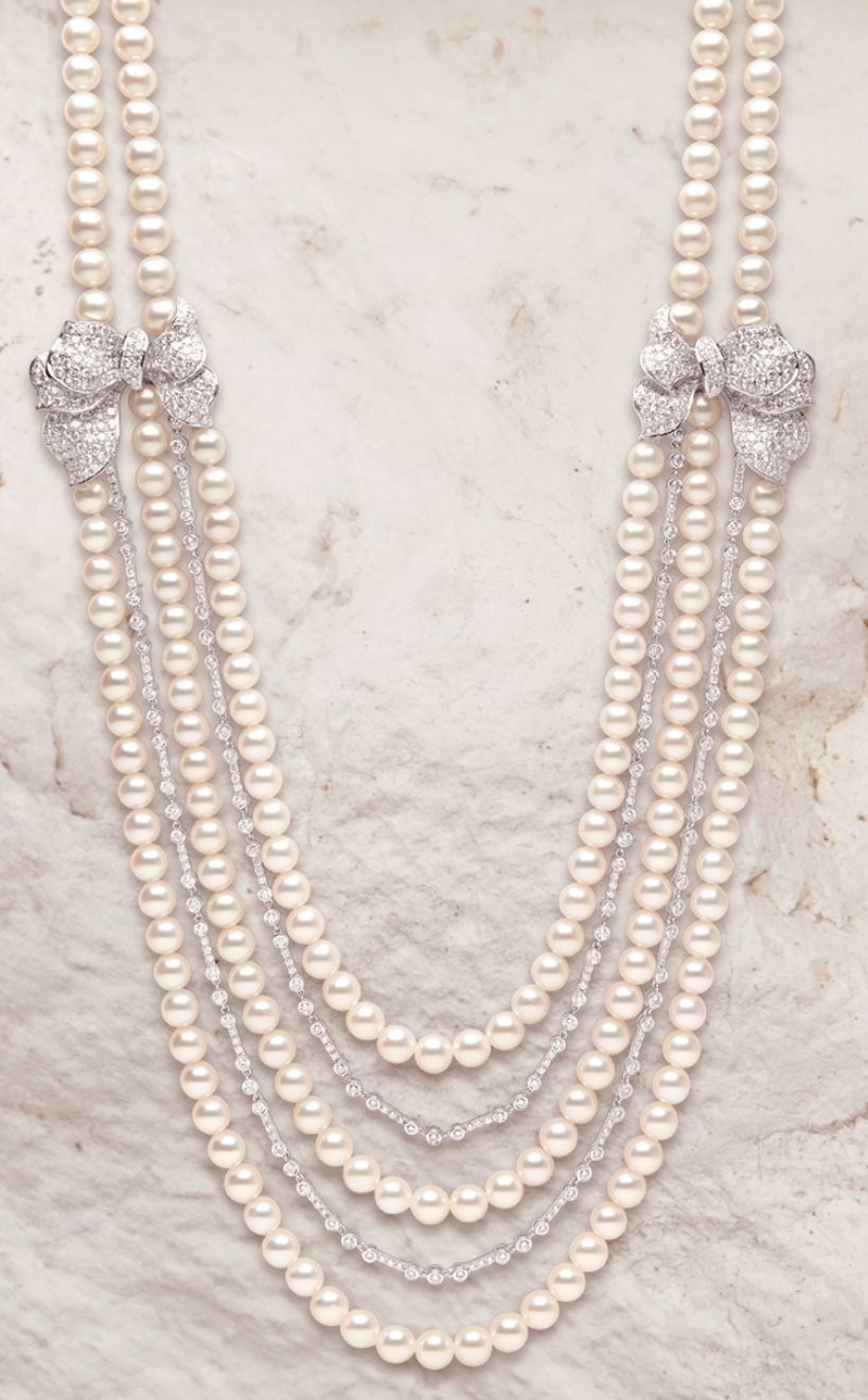 multiple long strands of small pale beads