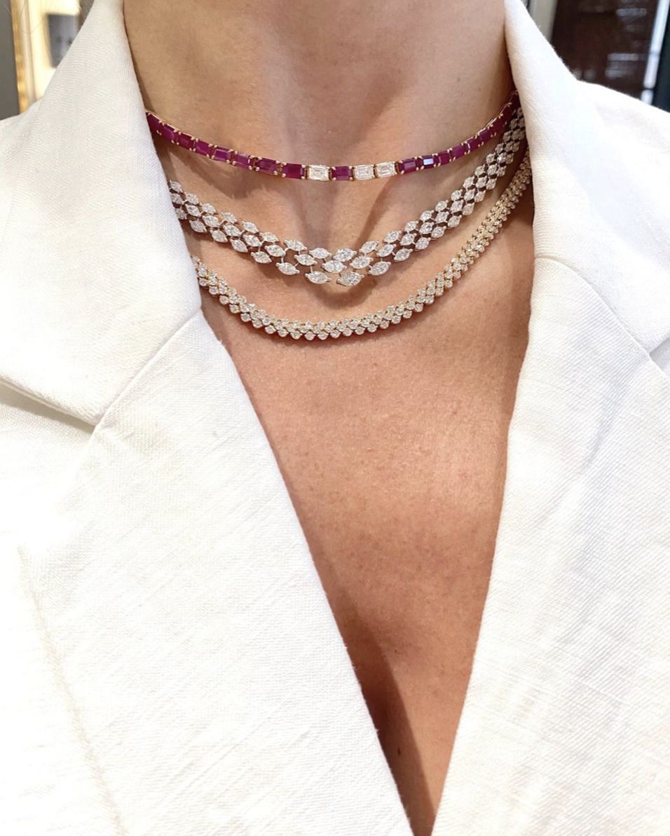 three fine chains arranged in graduated lengths