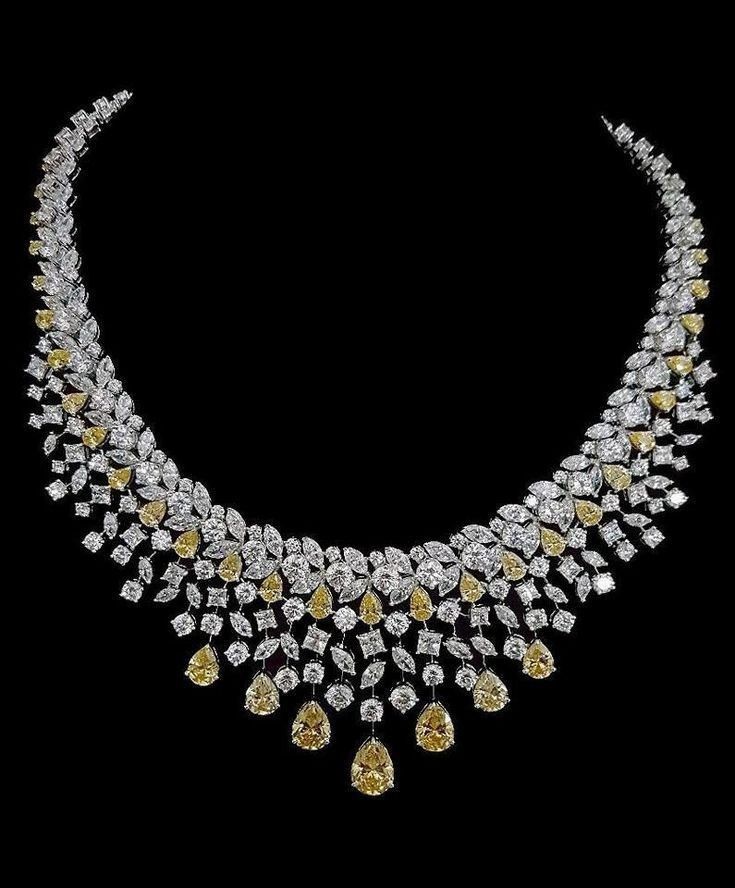 a curved necklace with warm-toned and pale accents