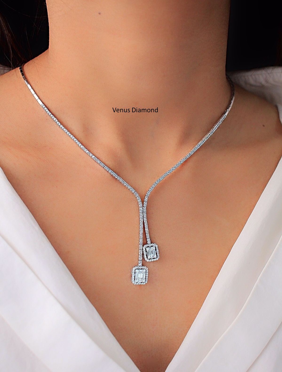 a fine chain with a centered pendant and hanging details