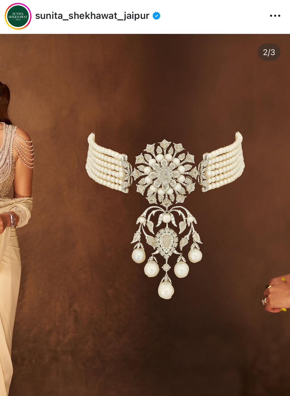 a close-fitting necklace with a wing-like center ornament