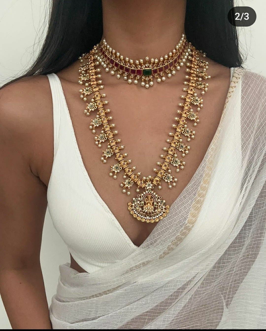 an ornate necklace shown with matching pieces